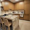 Porcelain waterfall counter top, stained rift oak veneer cabinets 