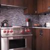 Walnut cabinets,  glass mosaic backsplash